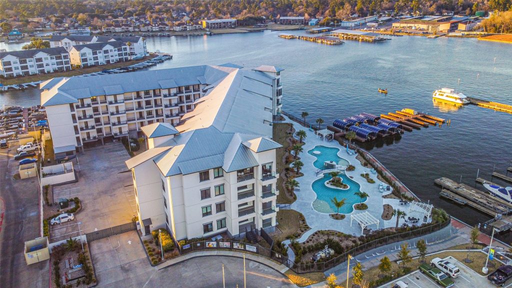 Aerial view of luxury condos on Lake Conroe during the sunset.