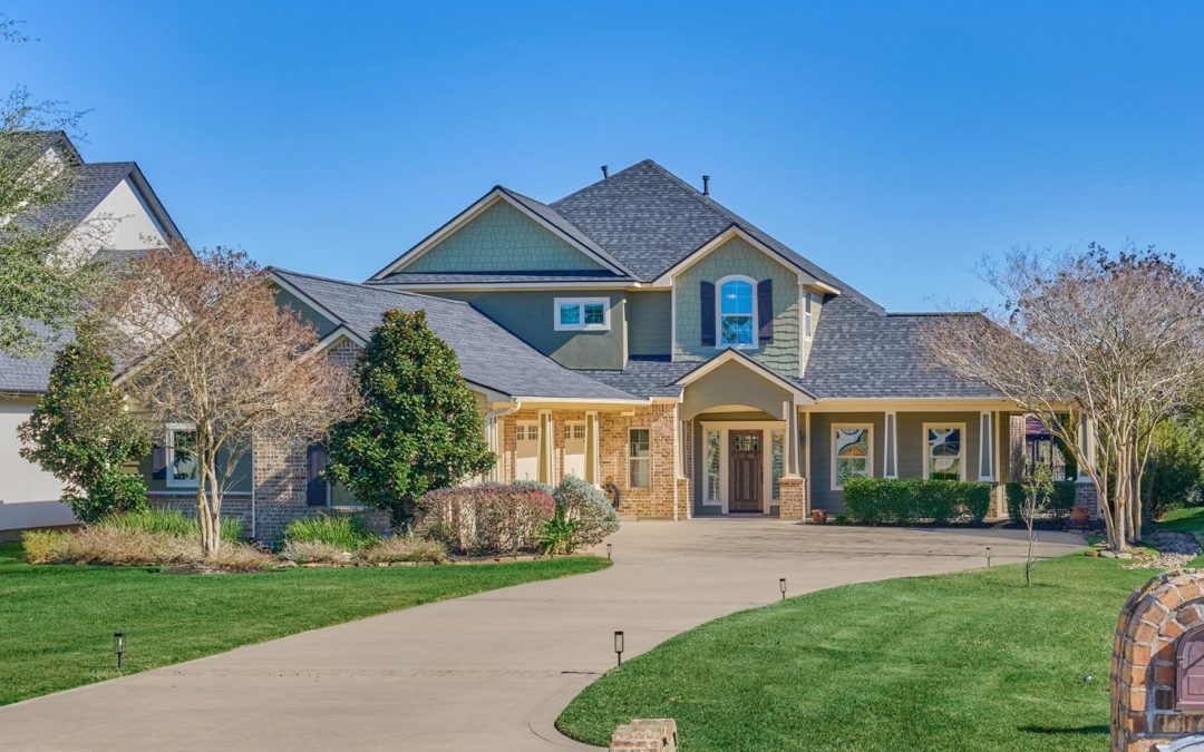 Exterior view of the front of a large lake house.