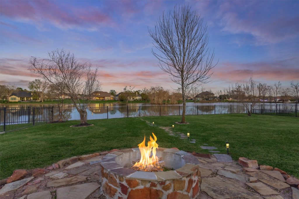 A firepit in the backyard at sunset overlooking the lake. 
