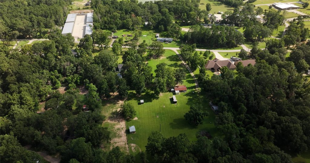 Wide shot from above of an off-water neighborhood home in the Lake Conroe area.