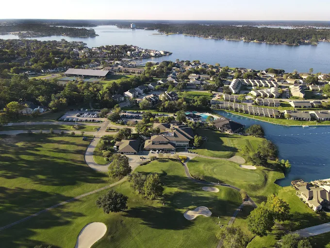 Aerial view of April Sound Country Club and neighboring homes by Lake Conroe.